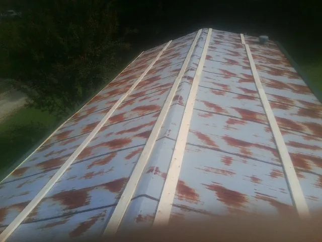 Rusted metal roof panels with new wood purlins before replacement — Storm Damage Roof Repair in Calumet City by Roofing Brothers