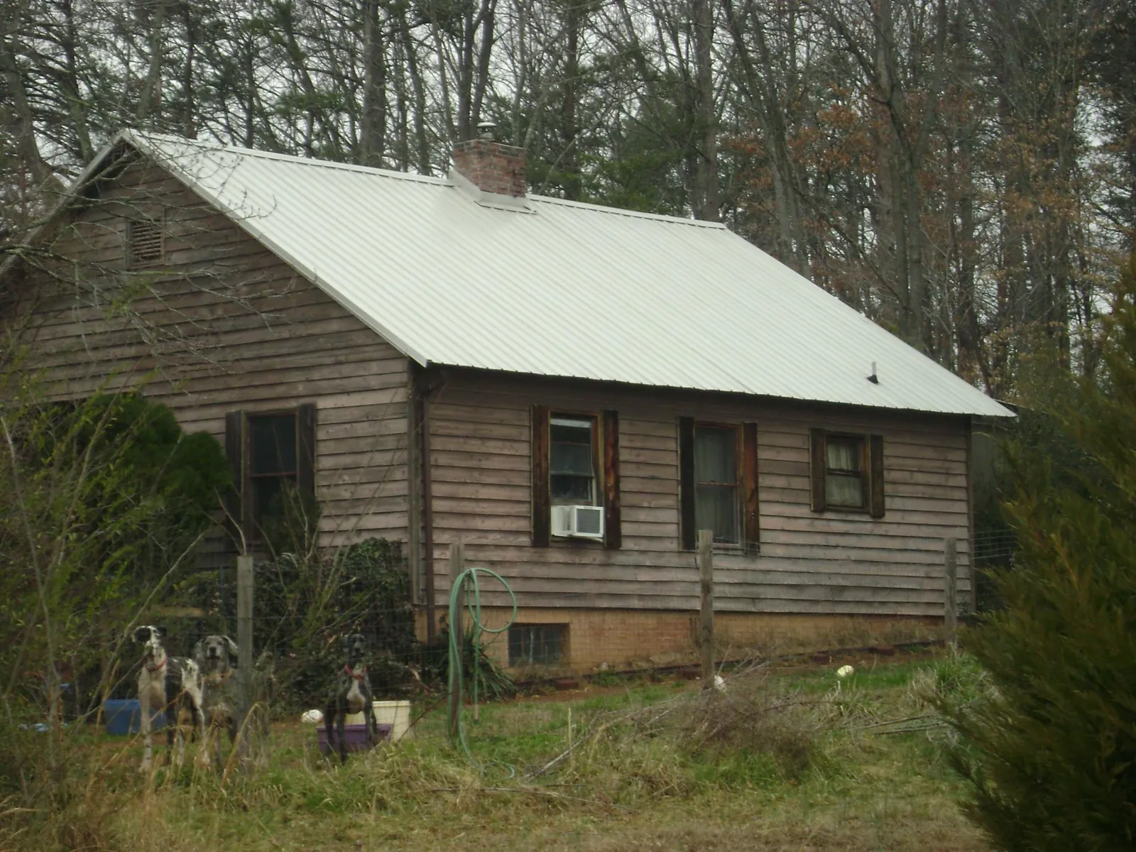 White metal roof on an old wood sided farmhouse, from a Metal Roof Installation job in Calumet City